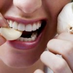 Девушка собирается съесть чеснок